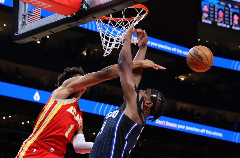 ATLANTA, GEORGIA - FEBRUARY 25:  Jalen Johnson #1 of the Atlanta Hawks blocks a dunk attempt by Wendell Carter Jr. #34 of the Orlando Magic during the first quarter at State Farm Arena on February 25, 2024 in Atlanta, Georgia.  NOTE TO USER: User expressly acknowledges and agrees that, by downloading and/or using this photograph, user is consenting to the terms and conditions of the Getty Images License Agreement.  (Photo by Kevin C. Cox/Getty Images)