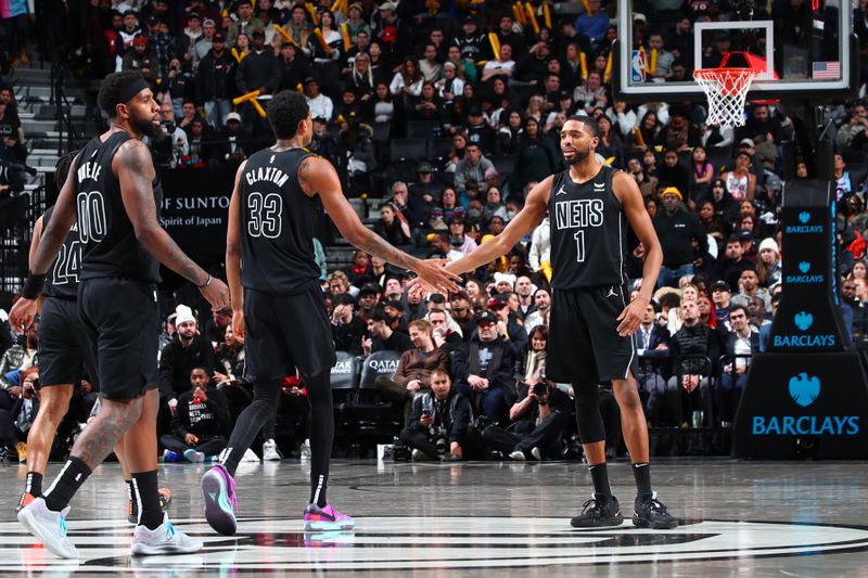 BROOKLYN, NY - JANUARY 15: Nicolas Claxton #33 of the Brooklyn Nets high fives Mikal Bridges #1 of the Brooklyn Nets during the game against the Miami Heat on January 15, 2024 at Barclays Center in Brooklyn, New York. NOTE TO USER: User expressly acknowledges and agrees that, by downloading and or using this Photograph, user is consenting to the terms and conditions of the Getty Images License Agreement. Mandatory Copyright Notice: Copyright 2024 NBAE (Photo by David Nemec/NBAE via Getty Images)