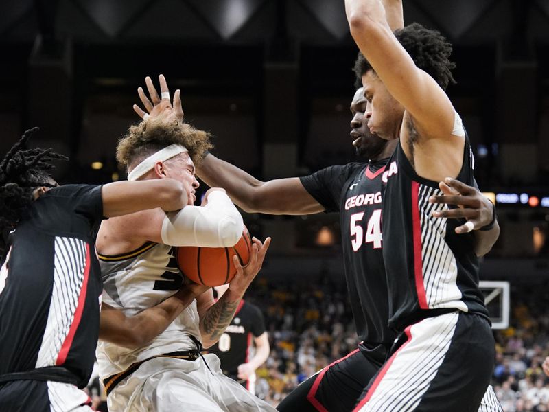 Jan 6, 2024; Columbia, Missouri, USA; Georgia Bulldogs guard Silas Demary Jr. (4) and Missouri Tigers forward Noah Carter (35) and center Russel Tchewa (54) fight for a rebound during the first half at Mizzou Arena. Mandatory Credit: Denny Medley-USA TODAY Sports