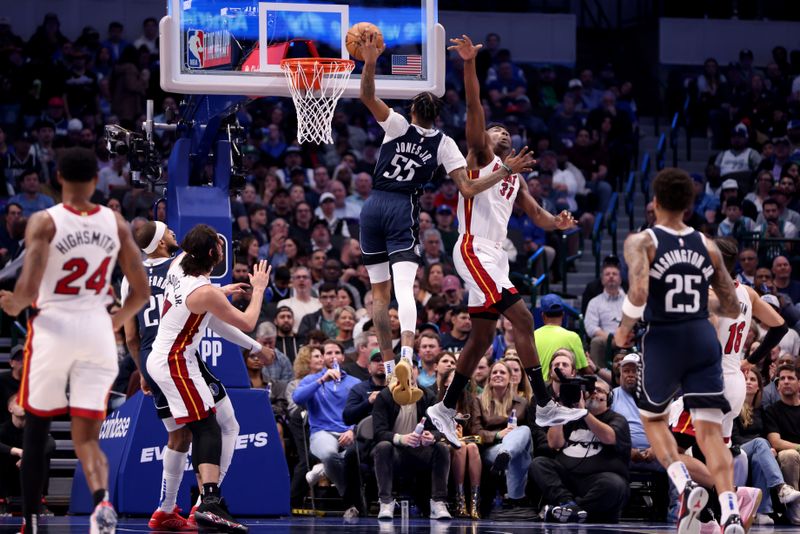 DALLAS, TEXAS - MARCH 07: Derrick Jones Jr. #55 of the Dallas Mavericks misses a dunk while defended by Thomas Bryant #31 of the Miami Heat in the first half at American Airlines Center on March 07, 2024 in Dallas, Texas.  NOTE TO USER: User expressly acknowledges and agrees that, by downloading and or using this photograph, User is consenting to the terms and conditions of the Getty Images License Agreement. (Photo by Tim Heitman/Getty Images)