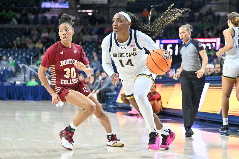 Jan 11, 2024; South Bend, Indiana, USA; Notre Dame Fighting Irish guard KK Bransford (14) dribbles past Boston College Eagles guard T'Yana Todd (30) in the second half at the Purcell Pavilion. Mandatory Credit: Matt Cashore-USA TODAY Sports