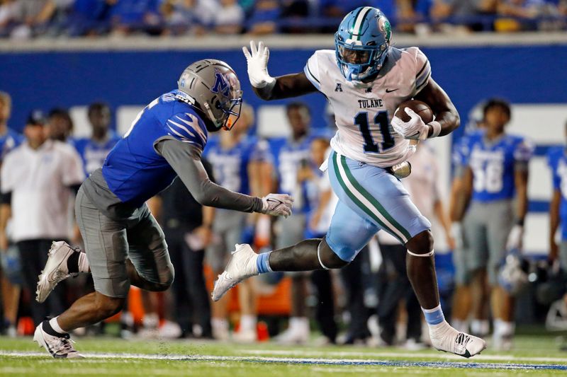 Oct 13, 2023; Memphis, Tennessee, USA; Tulane Green Wave tight end Chris Carter (11) runs after a catch as Memphis Tigers defensive back Simeon Blair (5) attempts to make the tackle during the second half at Simmons Bank Liberty Stadium. Mandatory Credit: Petre Thomas-USA TODAY Sports