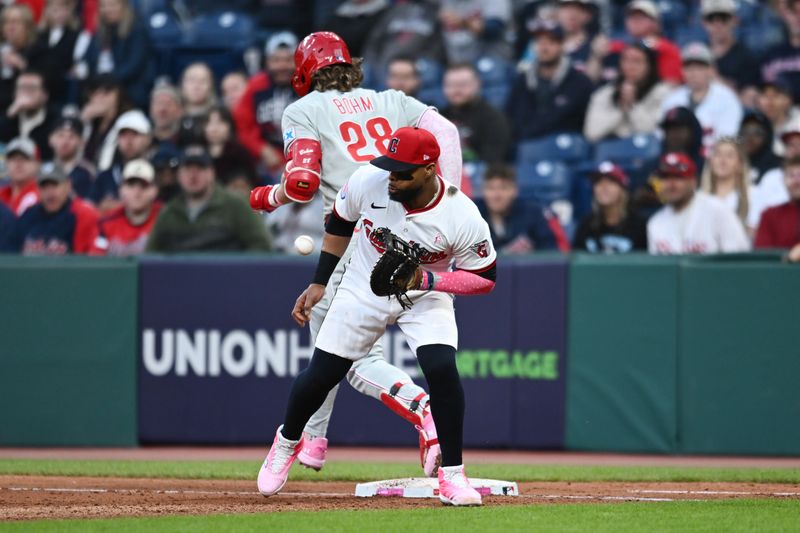 May 11, 2025; Cleveland, Ohio, USA; Philadelphia Phillies third baseman Alec Bohm (28) is safe at first as Cleveland Guardians first baseman Carlos Santana (41) fields the ball during the fifth inning at Progressive Field. Mandatory Credit: Ken Blaze-Imagn Images