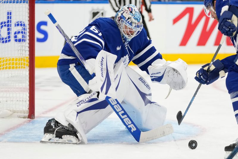 Oct 24, 2024; Toronto, Ontario, CAN; Toronto Maple Leafs goaltender Joseph Woll (60) tracks a puck shot by the St. Louis Blues during the second period at Scotiabank Arena. Mandatory Credit: John E. Sokolowski-Imagn Images