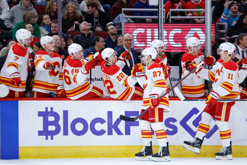 Jan 13, 2025; Chicago, Illinois, USA; Calgary Flames right wing Matt Coronato (27) celebrates with teammates after scoring against the Chicago Blackhawks during the first period at United Center. Mandatory Credit: Kamil Krzaczynski-Imagn Images