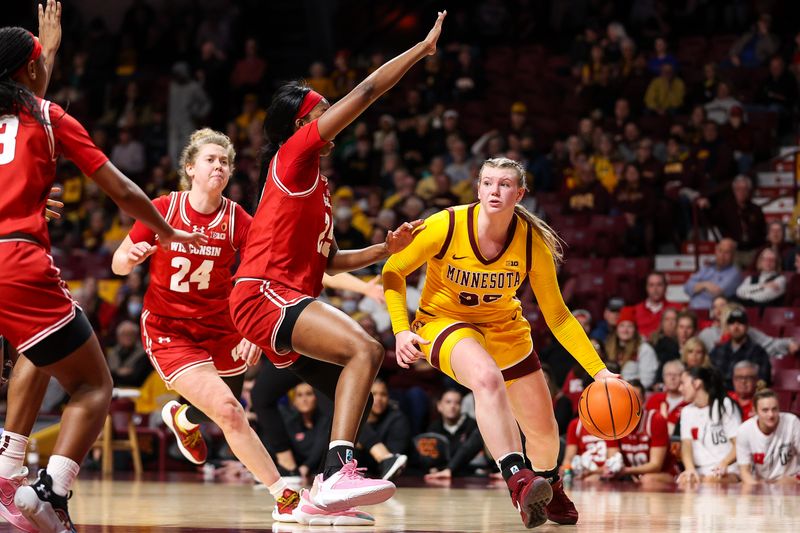 Feb 20, 2024; Minneapolis, Minnesota, USA; Minnesota Golden Gophers guard Grace Grocholski (25) dribbles as Wisconsin Badgers forward Serah Williams (25) defends during the first half at Williams Arena. Mandatory Credit: Matt Krohn-USA TODAY Sports