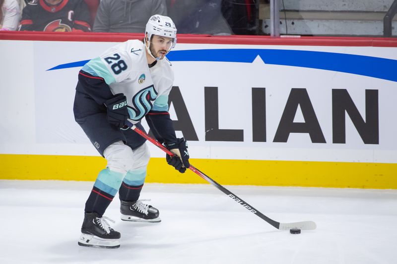 Nov 2, 2024; Ottawa, Ontario, CAN; Seattle Kraken defenseman Joshua Mahura (28) skates with the puck in the third period against the Ottawa Senators at the Canadian Tire Centre. Mandatory Credit: Marc DesRosiers-Imagn Images