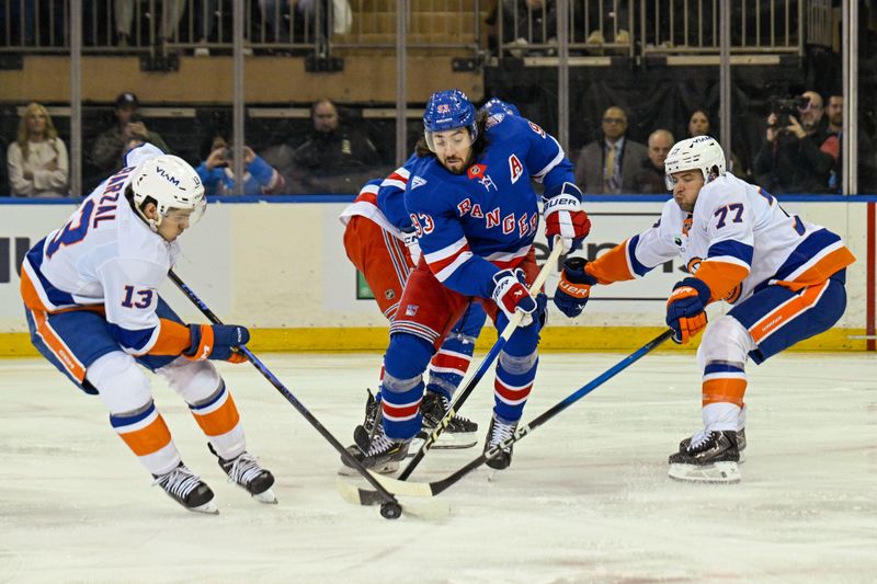 Jan 29, 2026; New York, New York, USA;  New York Islanders center Mathew Barzal (13) and defenseman Tony DeAngelo (77) battle New York Rangers center Mika Zibanejad (93) for a loose puck during the first period at Madison Square Garden. Mandatory Credit: Dennis Schneidler-Imagn Images