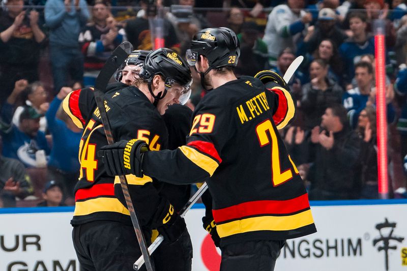Apr 6, 2025; Vancouver, British Columbia, CAN; Vancouver Canucks forward Aatu Raty (54) and defenseman Filip Hronek (17) and defenseman Marcus Pettersson (29) celebrate Raty’s goal against the Vegas Golden Knights in the second period at Rogers Arena. Mandatory Credit: Bob Frid-Imagn Images