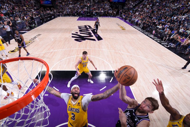 SACRAMENTO, CA - MARCH 13:  Domantas Sabonis #10 of the Sacramento Kings drives to the basket during the game as Anthony Davis #3 of the Los Angeles Lakers plays defense on March 13, 2024 at Golden 1 Center in Sacramento, California. NOTE TO USER: User expressly acknowledges and agrees that, by downloading and or using this Photograph, user is consenting to the terms and conditions of the Getty Images License Agreement. Mandatory Copyright Notice: Copyright 2024 NBAE (Photo by Rocky Widner/NBAE via Getty Images)