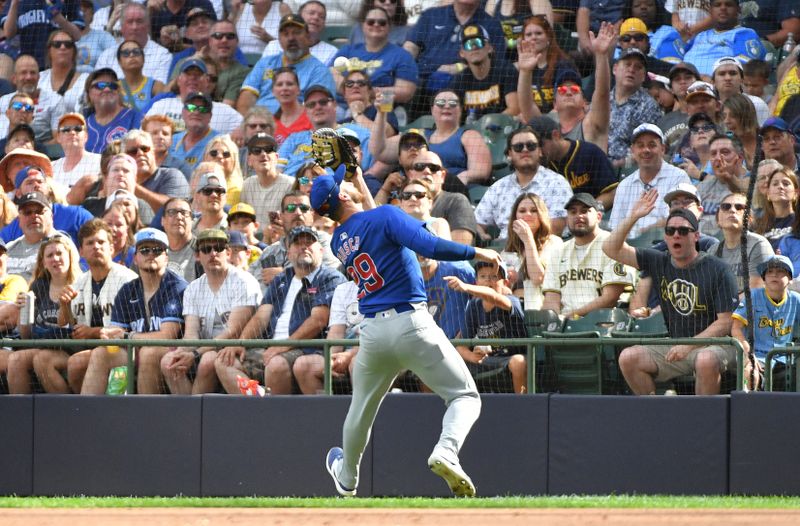 Jun 29, 2024; Milwaukee, Wisconsin, USA; Chicago Cubs first baseman Michael Busch (29) catches a fly ball near the first base line against the Milwaukee Brewers in the seventh inning at American Family Field. Mandatory Credit: Michael McLoone-USA TODAY Sports