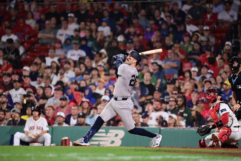 Jul 28, 2024; Boston, Massachusetts, USA; New York Yankees catcher Austin Wells (28) hits an RBI single against the Boston Red Sox during the seventh inning at Fenway Park. Mandatory Credit: Eric Canha-USA TODAY Sports