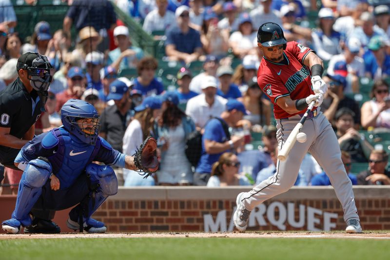 Jul 19, 2024; Chicago, Illinois, USA; Arizona Diamondbacks catcher Gabriel Moreno (14) singles against the Chicago Cubs during the first inning at Wrigley Field. Mandatory Credit: Kamil Krzaczynski-USA TODAY Sports