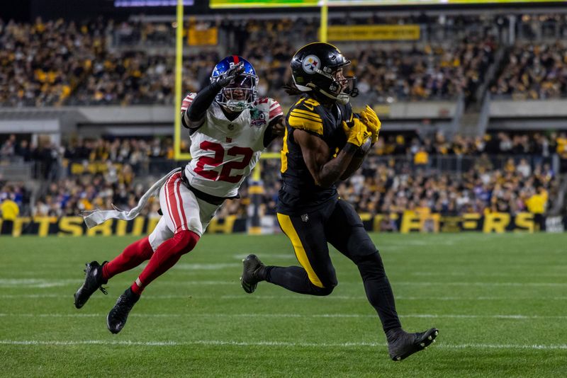 Pittsburgh Steelers wide receiver Calvin Austin III (19) catches a 29 yard touchdown in front of New York Giants cornerback Dru Phillips (22) during an NFL football game, Monday, Oct. 28, 2024, in Pittsburgh. (AP Photo/Matt Durisko)