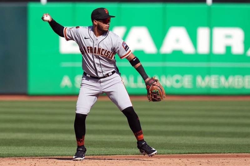 Aug 5, 2023; Oakland, California, USA; San Francisco Giants second baseman Thairo Estrada (39) throws the ball to first base against the Oakland Athletics during the second inning at Oakland-Alameda County Coliseum. Mandatory Credit: Darren Yamashita-USA TODAY Sports