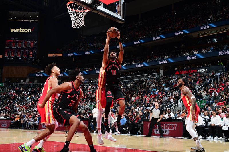 ATLANTA, GA - JANUARY 28: Bruce Brown #11 of the Toronto Raptors drives to the basket during the game against the Atlanta Hawks on January 28, 2024 at State Farm Arena in Atlanta, Georgia.  NOTE TO USER: User expressly acknowledges and agrees that, by downloading and/or using this Photograph, user is consenting to the terms and conditions of the Getty Images License Agreement. Mandatory Copyright Notice: Copyright 2024 NBAE (Photo by Scott Cunningham/NBAE via Getty Images)