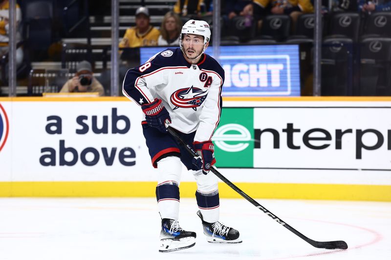 Oct 26, 2024; Nashville, Tennessee, USA; Columbus Blue Jackets defenseman Zach Werenski (8) picks up the puck at the bottom of the face-off circle in the first period against the Nashville Predators at Bridgestone Arena. Mandatory Credit: Casey Gower-Imagn Images