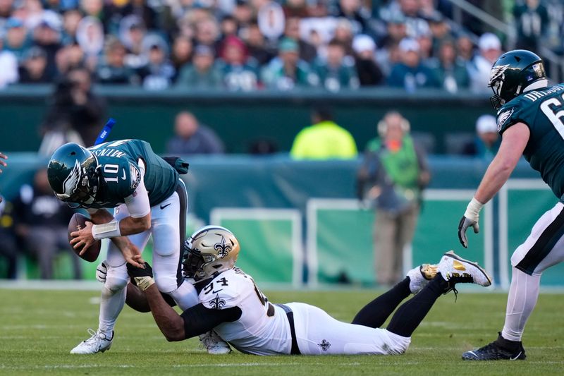 Philadelphia Eagles quarterback Gardner Minshew (10) is sacked by New Orleans Saints defensive end Cameron Jordan (94) in the second half of an NFL football game in Philadelphia, Sunday, Jan. 1, 2023. (AP Photo/Matt Slocum)