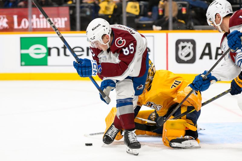 Nov 2, 2024; Nashville, Tennessee, USA;  Nashville Predators goaltender Juuse Saros (74) blocks the shot of Colorado Avalanche center Nikita Prishchepov (85) during the second period at Bridgestone Arena. Mandatory Credit: Steve Roberts-Imagn Images