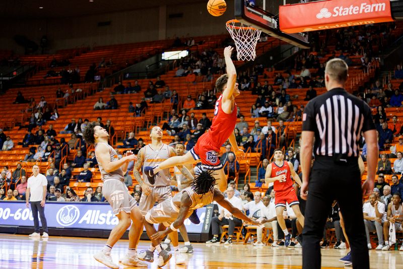 Feb 3, 2024; El Paso, Texas, USA; Liberty University Flames forward Zach Cleveland (25) tries to score against the UTEP Miners defense in the first half at Don Haskins Center. Mandatory Credit: Ivan Pierre Aguirre-USA TODAY Sports