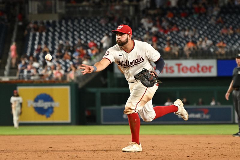 Aug 6, 2024; Washington, District of Columbia, USA; Washington Nationals first baseman Juan Yepez (18) tosses the ball to first base against the San Francisco Giants during the ninth inning at Nationals Park. Mandatory Credit: Rafael Suanes-USA TODAY Sports