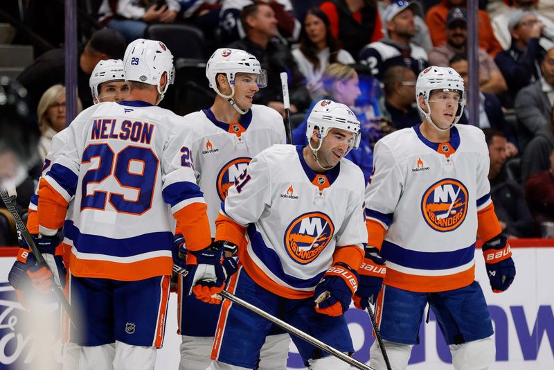 Oct 14, 2024; Denver, Colorado, USA; New York Islanders center Kyle Palmieri (21) celebrates his goal with defenseman Mike Reilly (2) and defenseman Scott Mayfield (24) and center Brock Nelson (29) and right wing Maxim Tsyplakov (7) in the first period at Ball Arena. Mandatory Credit: Isaiah J. Downing-Imagn Images