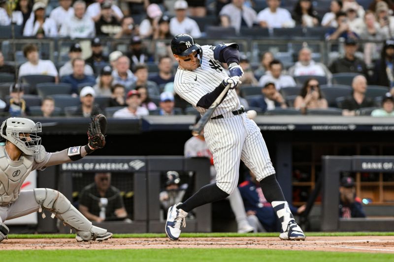 Jun 8, 2025; Bronx, New York, USA; New York Yankees outfielder Aaron Judge (99) hits a two-run home run against the Boston red Sox during the first inning at Yankee Stadium. Mandatory Credit: John Jones-Imagn Images