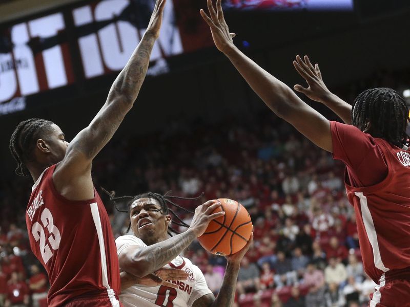 Mar 9, 2024; Tuscaloosa, Alabama, USA;  Arkansas guard Khalif Battle (0) works for a shot against Alabama forward Nick Pringle (23) and Alabama guard Davin Cosby Jr. (4) at Coleman Coliseum. Mandatory Credit: Gary Cosby Jr.-USA TODAY Sports