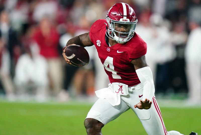 Nov 4, 2023; Tuscaloosa, Alabama, USA; Alabama Crimson Tide quarterback Jalen Milroe (4) scrambles up the field against the LSU Tigers during the second half at Bryant-Denny Stadium. Alabama Crimson Tide defeated the LSU Tigers 42-28. Mandatory Credit: John David Mercer-USA TODAY Sports