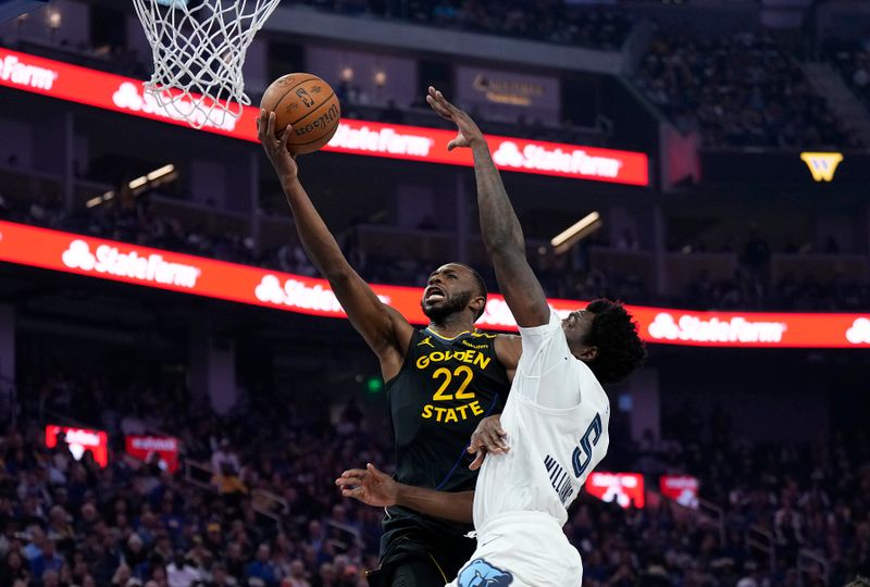 SAN FRANCISCO, CALIFORNIA - NOVEMBER 15: Andrew Wiggins #22 of the Golden State Warriors goes in for a layup over Vince Williams Jr. #5 of the Memphis Grizzlies in the first quarter during the Emirates NBA Cup game at Chase Center on November 15, 2024 in San Francisco, California. NOTE TO USER: User expressly acknowledges and agrees that, by downloading and or using this photograph, User is consenting to the terms and conditions of the Getty Images License Agreement. (Photo by Thearon W. Henderson/Getty Images)