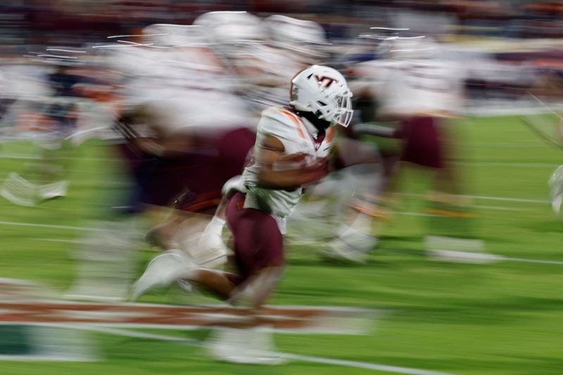 Nov 25, 2023; Charlottesville, Virginia, USA; DUPLICATE***Virginia Tech Hokies running back Bhayshul Tuten (33) carries the ball against the Virginia Cavaliers during the fourth quarter at Scott Stadium. Mandatory Credit: Geoff Burke-USA TODAY Sports