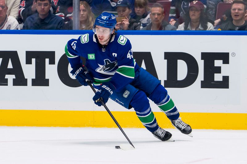 Feb 17, 2024; Vancouver, British Columbia, CAN; Vancouver Canucks defenseman Quinn Hughes (43) handles the puck against the Winnipeg Jets in the third period at Rogers Arena. Jets won 4-2. Mandatory Credit: Bob Frid-USA TODAY Sports