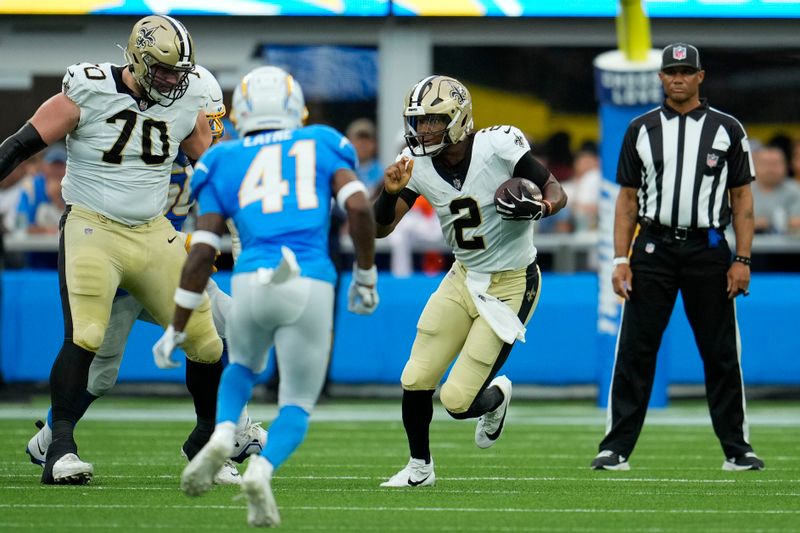 New Orleans Saints quarterback Jameis Winston (2) scrambles in the first half of an NFL football game against the Los Angeles Chargers in Inglewood, Calif., Sunday, Aug. 20, 2023. (AP Photo/Marcio Jose Sanchez)