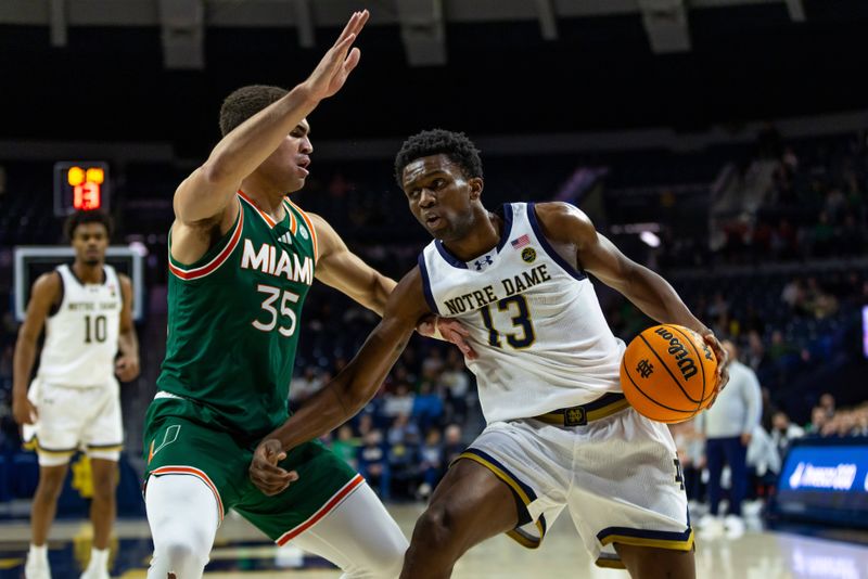 Jan 13, 2026; South Bend, Indiana, USA; Notre Dame Fighting Irish guard Sir Mohammed (13) works against Miami (FL) Hurricanes guard Dante Allen (35) during the first half at Purcell Pavilion at the Joyce Center. Mandatory Credit: Michael Caterina-Imagn Images