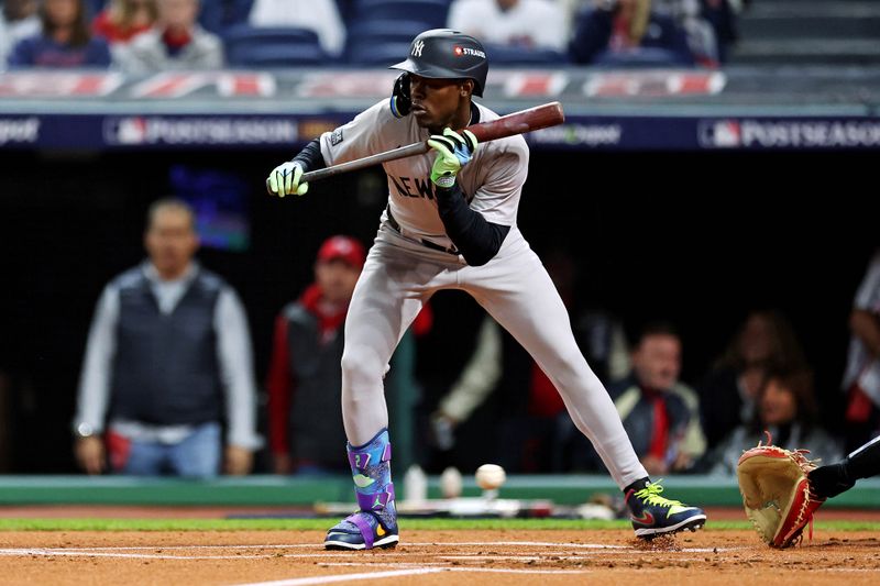 Oct 19, 2024; Cleveland, Ohio, USA; New York Yankees third base Jazz Chisholm Jr. (13) is hit by a pitch in the foot during the first inning against the Cleveland Guardians during game five of the ALCS for the 2024 MLB playoffs at Progressive Field. Mandatory Credit: Scott Galvin-Imagn Images