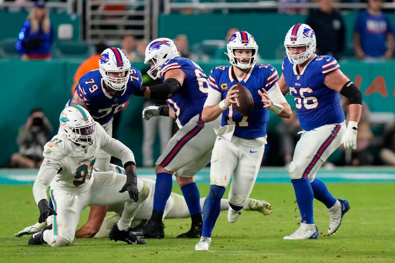 Buffalo Bills quarterback Josh Allen scrambles with the ball during the second half of an NFL football game against the Miami Dolphins, Sunday, Jan. 7, 2024, in Miami Gardens, Fla. (AP Photo/Wilfredo Lee)