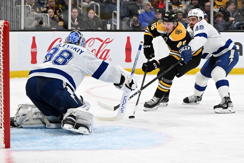 Jan 14, 2025; Boston, Massachusetts, USA; Boston Bruins left wing Cole Koepke (45) skates against Tampa Bay Lightning defenseman Nick Perbix (48) and goaltender Andrei Vasilevskiy (88) during the third period at the TD Garden. Mandatory Credit: Brian Fluharty-Imagn Images