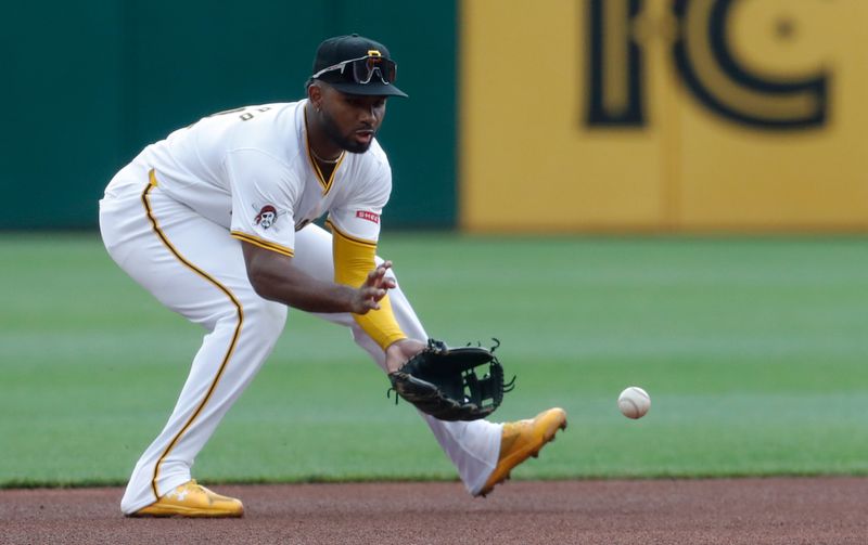 Sep 26, 2024; Pittsburgh, Pennsylvania, USA;  Pittsburgh Pirates shortstop Liover Peguero (31) fields a ground ball for an out against Milwaukee Brewers second baseman Brice Turang (not pictured) during the first inning at PNC Park. Mandatory Credit: Charles LeClaire-Imagn Images