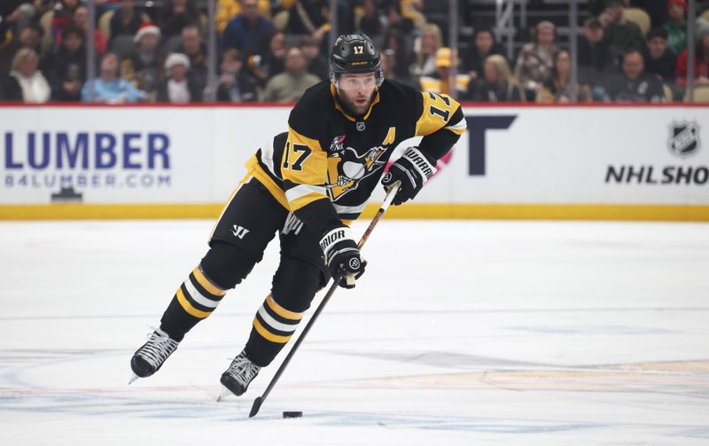 Dec 21, 2025; Pittsburgh, Pennsylvania, USA;  Pittsburgh Penguins right wing Bryan Rust (17) skates up ice with the puck against the Montréal Canadiens during the first period at PPG Paints Arena. Mandatory Credit: Charles LeClaire-Imagn Images