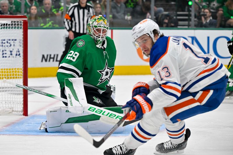 May 23, 2024; Dallas, Texas, USA; Edmonton Oilers center Mattias Janmark (13) looks for the puck in front of Dallas Stars defenseman Jerad Rosburg (39) during the first period in game one of the Western Conference Final of the 2024 Stanley Cup Playoffs at American Airlines Center. Mandatory Credit: Jerome Miron-USA TODAY Sports