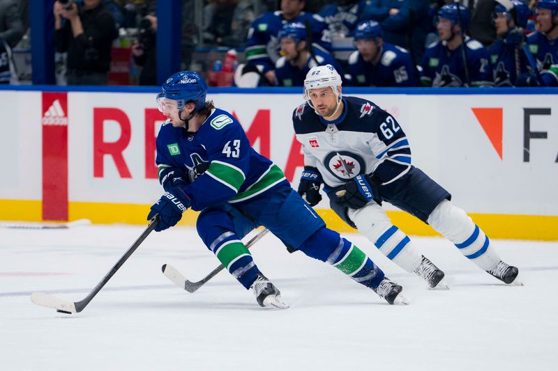 Feb 17, 2024; Vancouver, British Columbia, CAN; Winnipeg Jets forward Nino Niederreiter (62) pursues Vancouver Canucks defenseman Quinn Hughes (43) in the third period at Rogers Arena. Jets won 4-2. Mandatory Credit: Bob Frid-USA TODAY Sports