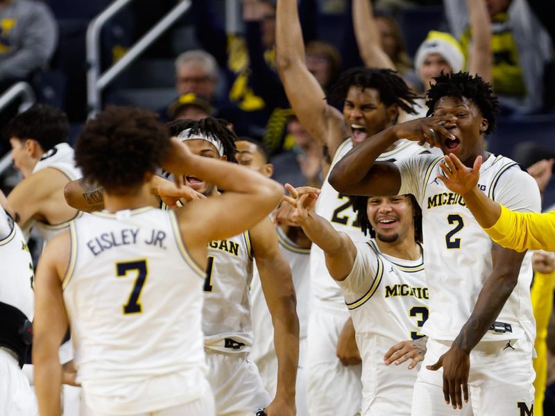 Dec 21, 2025; Ann Arbor, Michigan, USA; The bench Michigan Wolverines bench reacts as guard Howard Eisley Jr. (7) scores a three pointer late in the second half against the La Salle University Explorers at Crisler Center. Mandatory Credit: Brian Bradshaw Sevald-Imagn Images