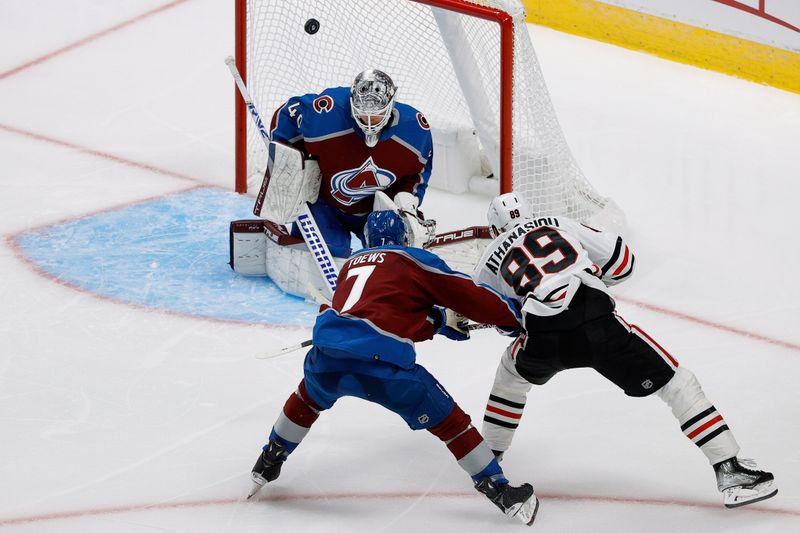 Oct 19, 2023; Denver, Colorado, USA; Colorado Avalanche goaltender Alexandar Georgiev (40) deflects a shot from Chicago Blackhawks center Andreas Athanasiou (89) as defenseman Devon Toews (7) defends in the third period at Ball Arena. Mandatory Credit: Isaiah J. Downing-USA TODAY Sports