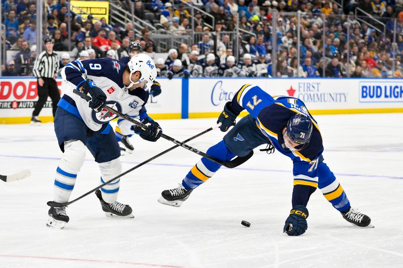 Dec 17, 2025; St. Louis, Missouri, USA; Winnipeg Jets left wing Alex Iafallo (9) and St. Louis Blues right wing Mathieu Joseph (71) battle for the puck during the second period at Enterprise Center. Mandatory Credit: Jeff Curry-Imagn Images