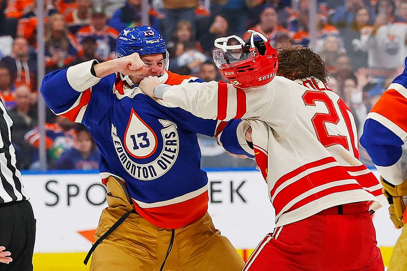 Feb 24, 2024; Edmonton, Alberta, CAN; Edmonton Oilers forward Mattias Janmark (13) and Calgary Flames forward Blake Coleman (20) fight during the second period at Rogers Place. Mandatory Credit: Perry Nelson-USA TODAY Sports