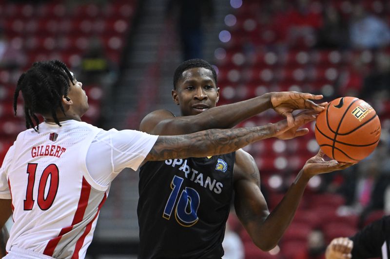 Feb 14, 2023; Las Vegas, Nevada, USA; UNLV Runnin' Rebels guard Keshon Gilbert (10) defends against San Jose State Spartans guard Omari Moore (10) in the second half at Thomas & Mack Center. Mandatory Credit: Candice Ward-USA TODAY Sports