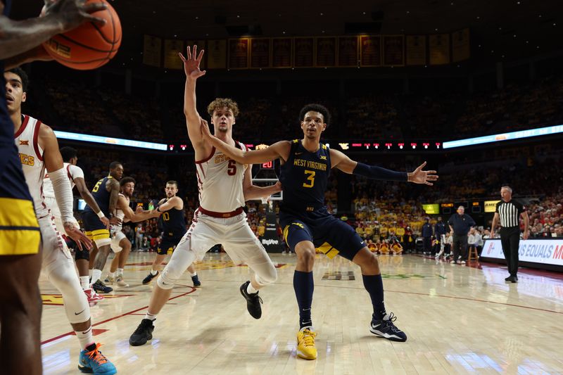 Feb 27, 2023; Ames, Iowa, USA; Iowa State Cyclones forward Aljaz Kunc (5) and West Virginia Mountaineers forward Tre Mitchell (3) battle for an inbound pass during the first half at James H. Hilton Coliseum. Mandatory Credit: Reese Strickland-USA TODAY Sports