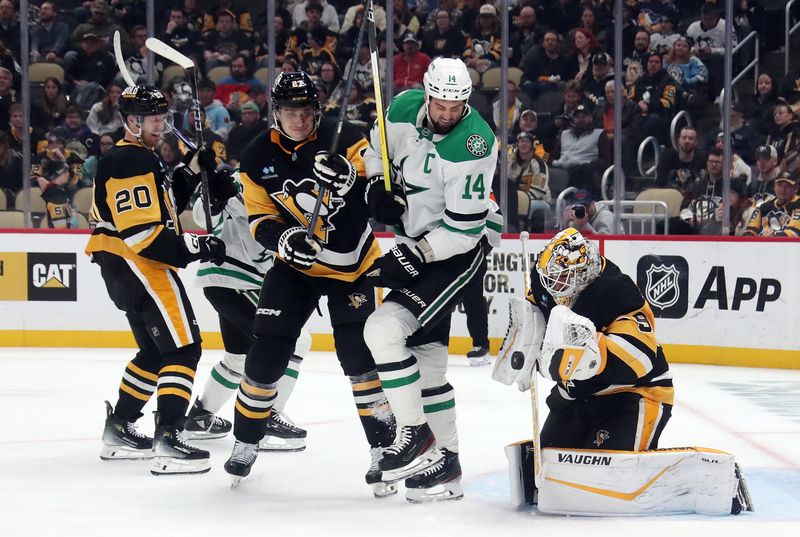 Nov 11, 2024; Pittsburgh, Pennsylvania, USA;  Pittsburgh Penguins goaltender Alex Nedeljkovic (39) makes a save behind a screen by Dallas Stars left wing Jamie Benn (14) during the second period at PPG Paints Arena. Mandatory Credit: Charles LeClaire-Imagn Images