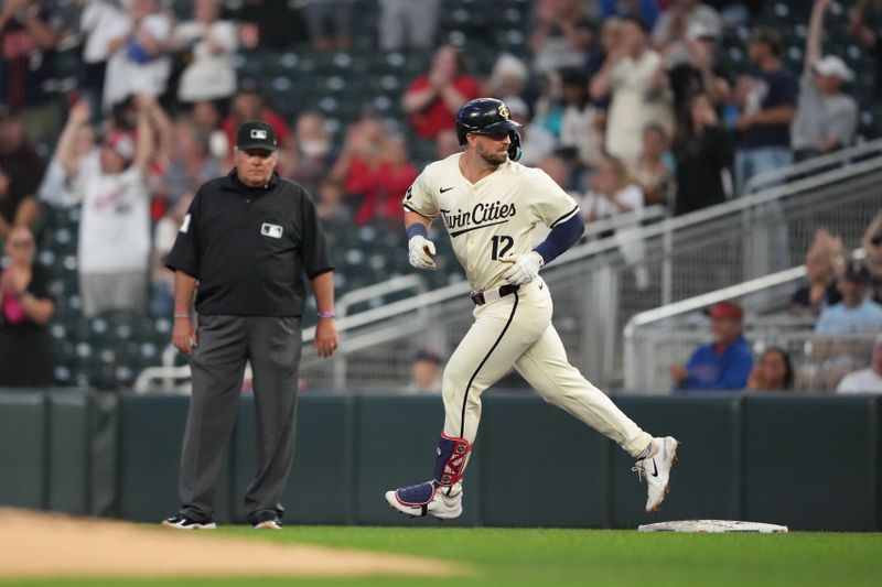 Sep 10, 2024; Minneapolis, Minnesota, USA; Minnesota Twins third baseman Kyle Farmer (12) looks back after hitting a three-run home run during the second inning against the Los Angeles Angels at Target Field. Mandatory Credit: Jordan Johnson-Imagn Images