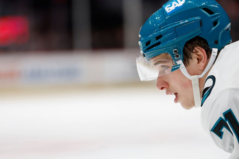 Dec 3, 2024; Washington, District of Columbia, USA; San Jose Sharks center Macklin Celebrini (71) lines up for a face-off against the Washington Capitals in the third period at Capital One Arena. Mandatory Credit: Geoff Burke-Imagn Images